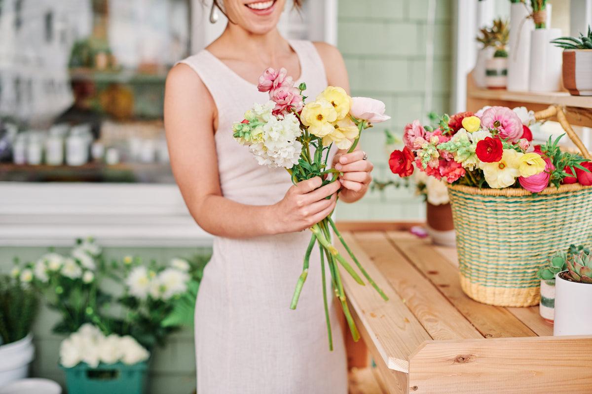 florist putting together a bouquet with spring flowers